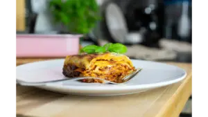 Close-up of dumpling lasagna topped with basil, showcasing traditional Italian cuisine
