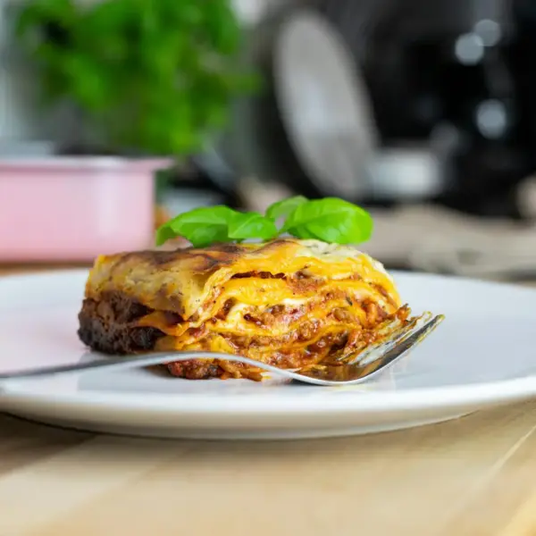 Close-up of dumpling lasagna topped with basil, showcasing traditional Italian cuisine