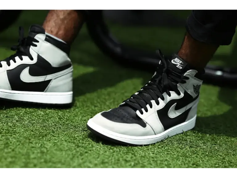 black and white Nike sneakers on a grassy surface outdoors, highlighting classic style and strong Jordan value for today’s sneaker fans.