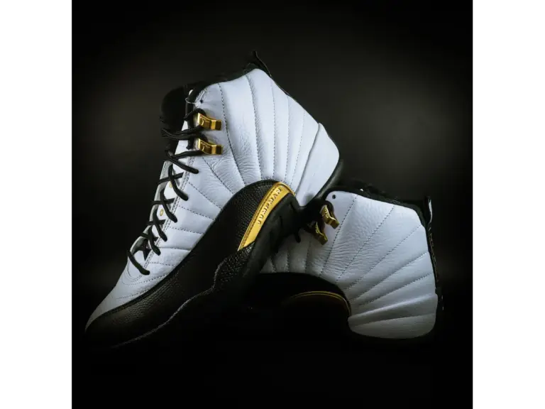 Close-up of stylish black and white rare Jordans featuring gold accents, ideal for fashion enthusiasts and sneaker collectors.