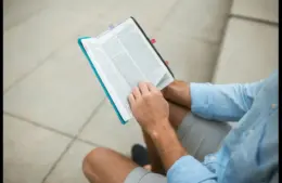 In the daily devotional, a man sits and reads the Bible.