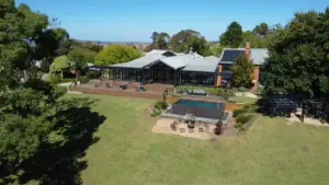 Aerial view of a homestead function with solar panels and garden in Lancefield, Victoria, Australia