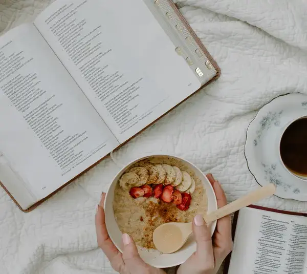 In daily devotional, someone has morning Bible study with coffee and cereal.