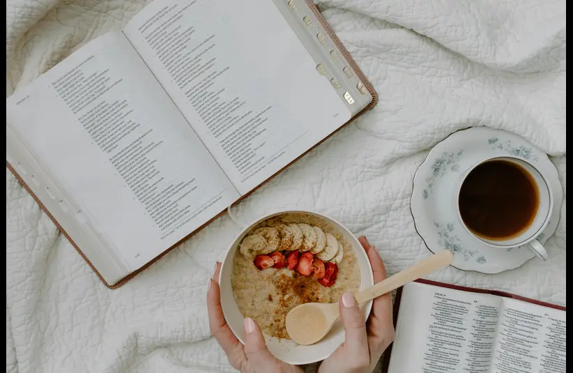 In daily devotional, someone has morning Bible study with coffee and cereal.