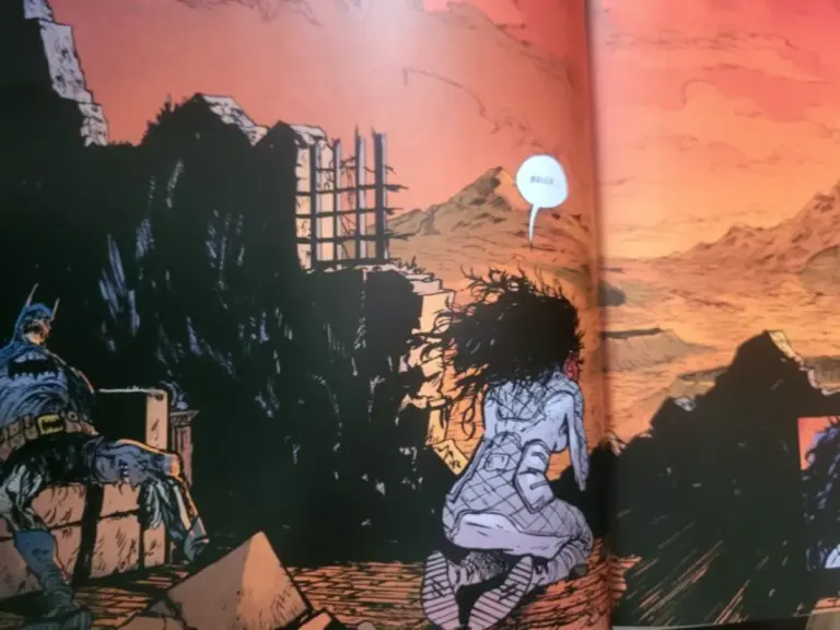 A comic panel showing Batman slumped on rubble at sunset while a woman kneels nearby, saying "Bruce," with a desolate landscape in the background.