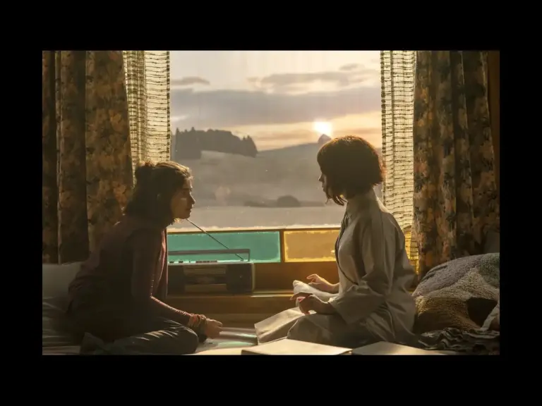 Two characters in Klara and the Sun talking to each other by a window.