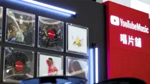 A wall of pictures next to a wall with the words "Youtube Music Night."
