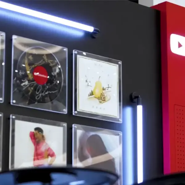 A wall of pictures next to a wall with the words "Youtube Music Night."