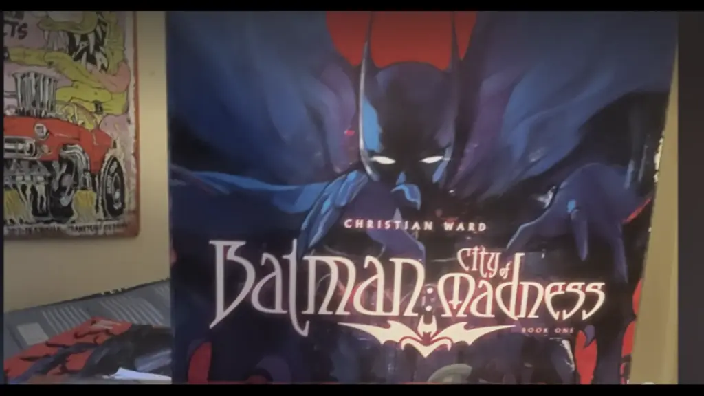 Cover of "Batman: City of Madness" by Christian Ward. Batman looms in a dark, eerie setting, with bold, gothic text and a mysterious atmosphere. Number one for Steve's graphic novel list.