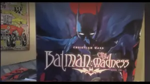 Cover of "Batman: City of Madness" by Christian Ward. Batman looms in a dark, eerie setting, with bold, gothic text and a mysterious atmosphere. Number one for Steve's graphic novel list.
