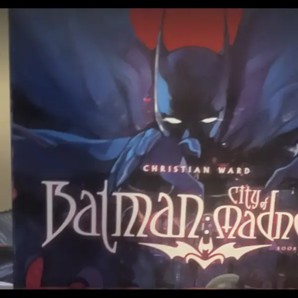 Cover of "Batman: City of Madness" by Christian Ward. Batman looms in a dark, eerie setting, with bold, gothic text and a mysterious atmosphere. Number one for Steve's graphic novel list.