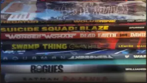 A stack of various comic books and graphic novels, including a prominent DC Black Label Batman book on top.