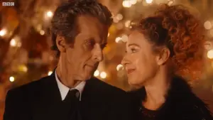 Doctor Who 2015 Christmas special The Husbands of River Song where The Doctor, played by Peter Capaldi, and a River Song, played by Alex stand closely, gazing at each other with warm smiles. The background is softly blurred with glowing lights, creating a cozy, intimate atmosphere.