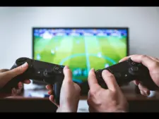 two people playing a football video Pocket Advance handheld game.