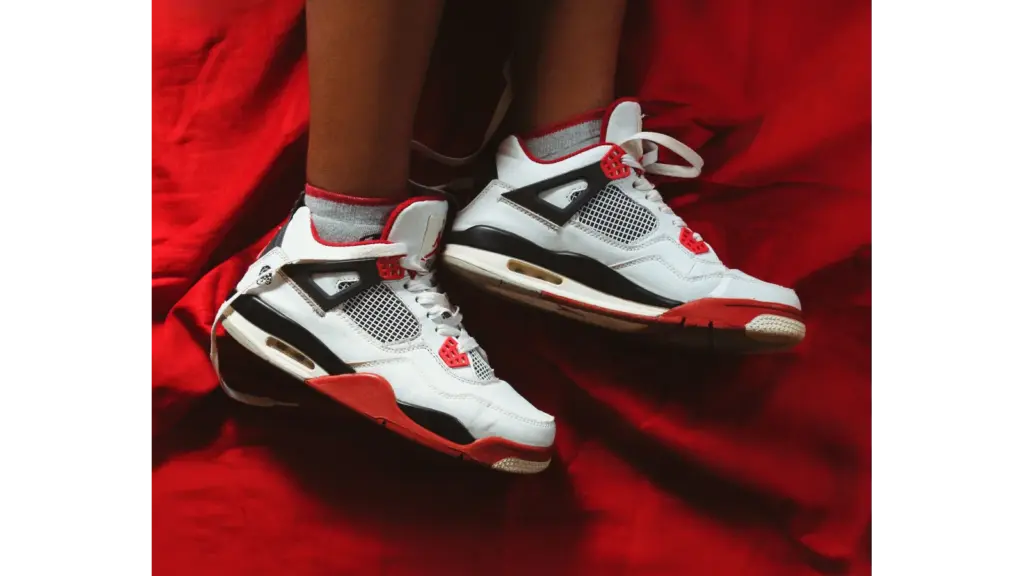 Close-up of kids' jordans on a vibrant red fabric