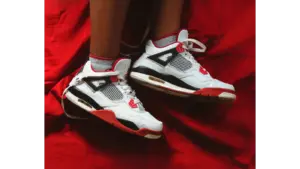 Close-up of kids' jordans on a vibrant red fabric