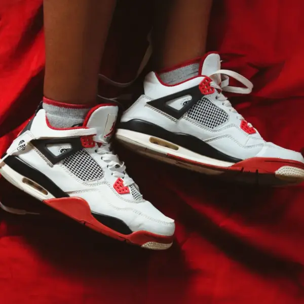 Close-up of kids' jordans on a vibrant red fabric
