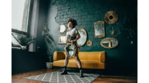 Statement mirrors frame a fashionable woman posing with a mirror in a chic room, reflecting contemporary style with bold, modern flair