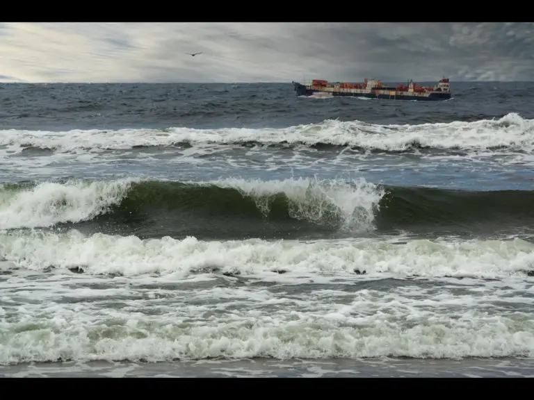 In daily devotional, a storm at sea tosses a small ship sailing across the water.