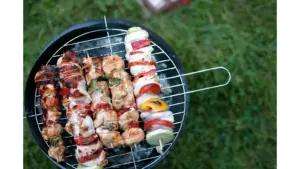 Close-up view of colorful chicken skewers on a charcoal grill