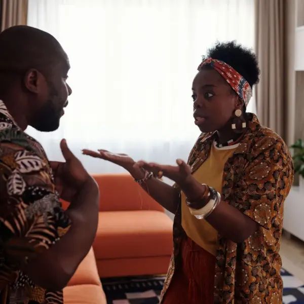 Arguing dreams come to life as a couple argues passionately in their living room, expressing raw emotions through intense gestures and heated energy.