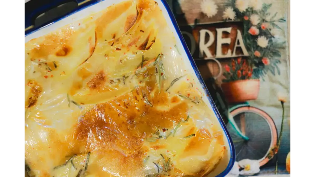 rich and creamy potatoes freshly baked, golden and crispy in a ceramic dish.