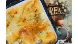 rich and creamy potatoes freshly baked, golden and crispy in a ceramic dish.