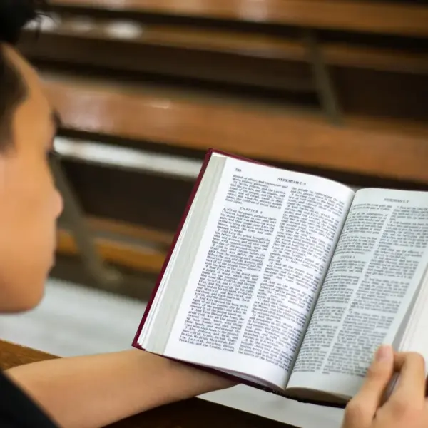 In daily devotional, a young man reads the Bible.