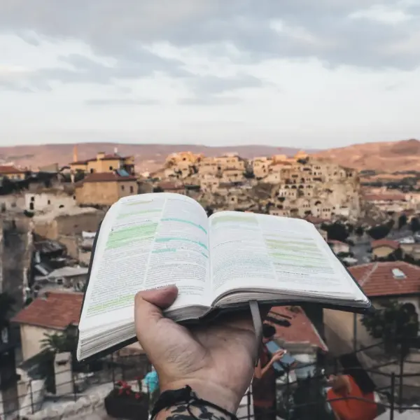 In daily devotional, an open Bible is held out over the city of Jerusalem.