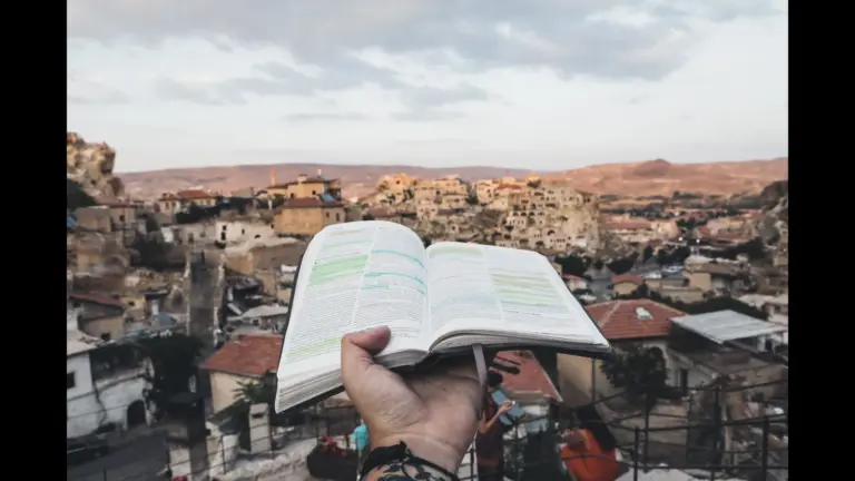 In daily devotional, an open Bible is held out over the city of Jerusalem.