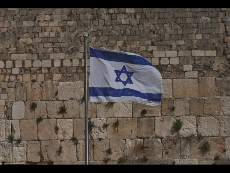 In daily devotional, part of the Jerusalem wall is shown with the nation's flag displaying the star of David.