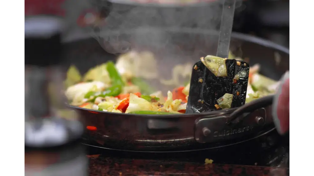a vibrant stir fry of fresh vegetables sizzling in a pan, releasing steam and capturing the same bold, chaotic energy found in dirty cabbage dishes.