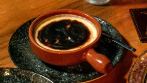 Recipe fails show up fast when you’re staring at a close‑up of a rich burnt Basque cheesecake served in a traditional ceramic dish on a wooden table.