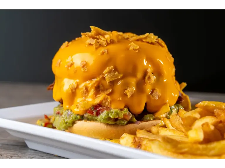 Fast food cravings hit hard when you’re staring at a delicious cheesy burger topped with guacamole and served with crispy fries.