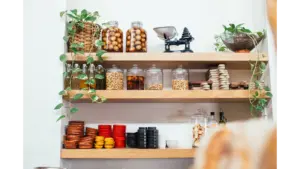 Stylish pantry shelves with glass jars, bowls, and greenery create a decorative, organized look that elevates any kitchen upgrade.