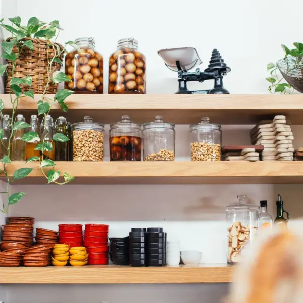 Stylish pantry shelves with glass jars, bowls, and greenery create a decorative, organized look that elevates any kitchen upgrade.