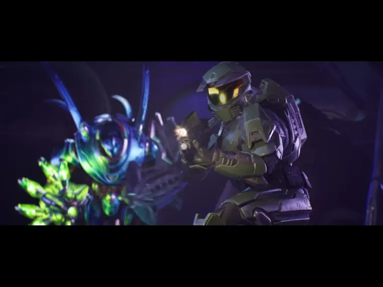 A character in armored suit blasting a gun in Halo gameplay.