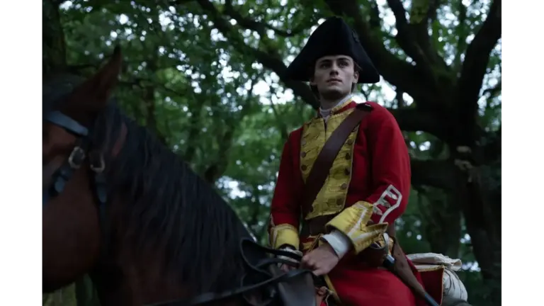 William Franklyn-Miller as Young Washington, dressed in a historical military uniform, sits on a horse amidst trees.