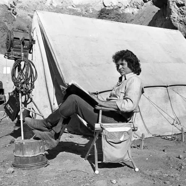 Michael Landon takes a break during filming of Little House on the Prairie to read the script.
