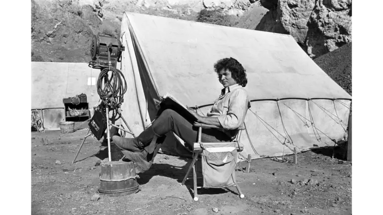 Michael Landon takes a break during filming of Little House on the Prairie to read the script.