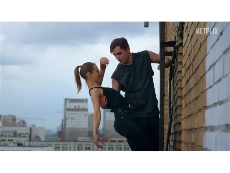 daredevil couple climbing a wall.