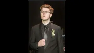 Technoblade in a suit with a gold pendant on it.