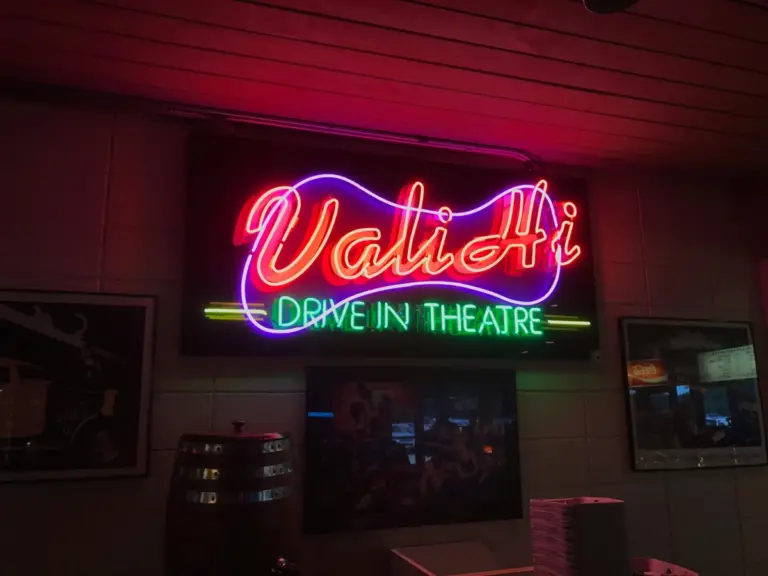 Red and green neon sign at the Vali Hi drive-in theatre in Lake Elmo, Minnesota glowing brightly during this drive‑in revival.