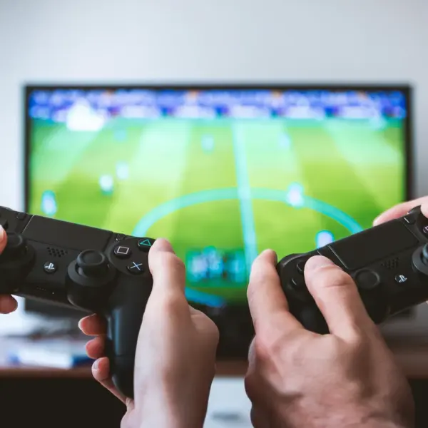 two people playing a football video game.
