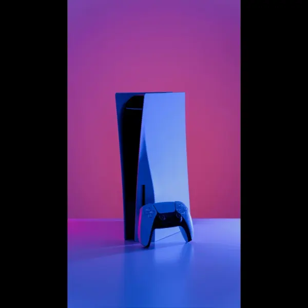 Sony's PlayStation 5 and controller under purple lighting.