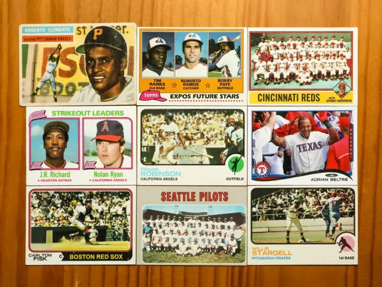 A collection of classic baseball cards on a brown wood table