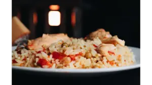 Close-up of a delicious chicken perlou meal with vegetables on a plate.