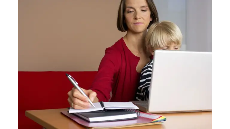 A woman multitasks with a child on her lap while working on a laptop at home, perfectly capturing how Call Preference shifts when real life and remote work collide.
