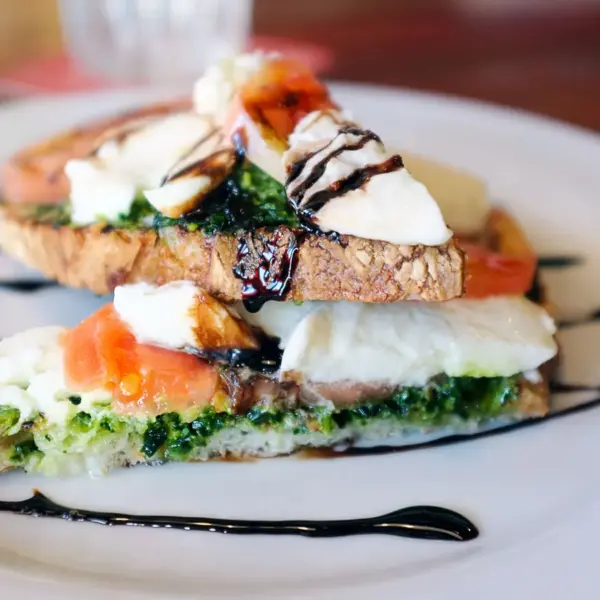 Delicious Caprese bruschetta with fresh mozzarella, tomatoes, and balsamic glaze drizzled on toast is one of those quick meals that feels fancy without the effort.