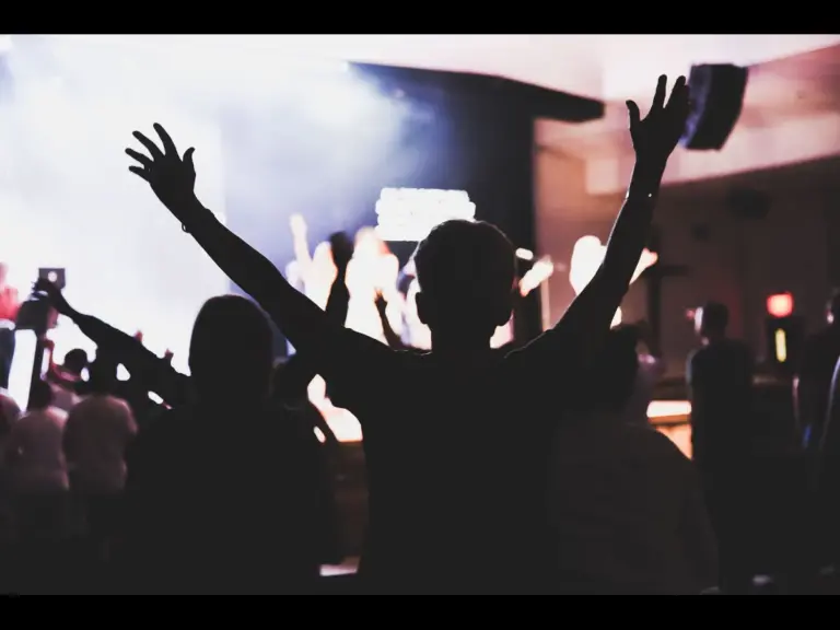 In this daily devotional, a group of believers rejoices and praises God in a church setting.